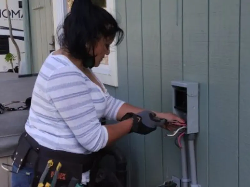 Licensed electrician wiring an exterior subpanel in Kenmore